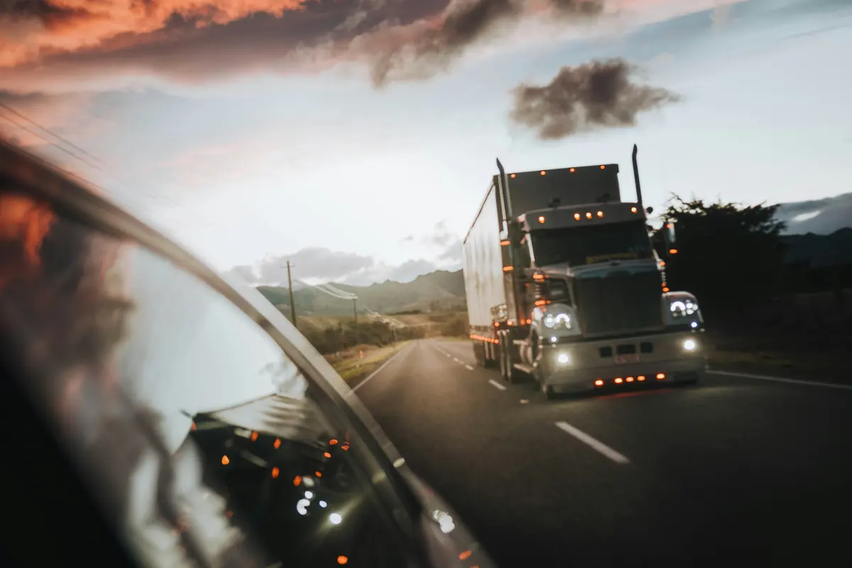 Tractor trailer running a two lane highway at dusk